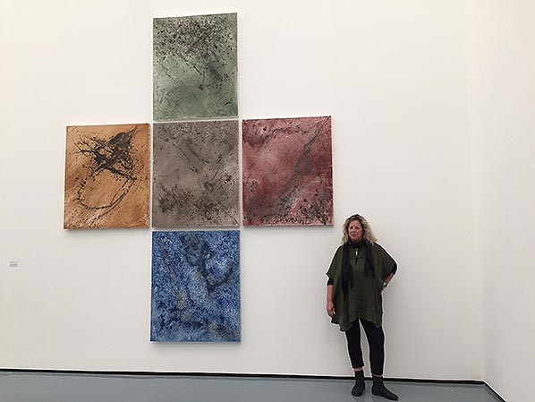 Ulrike in front of her paintings